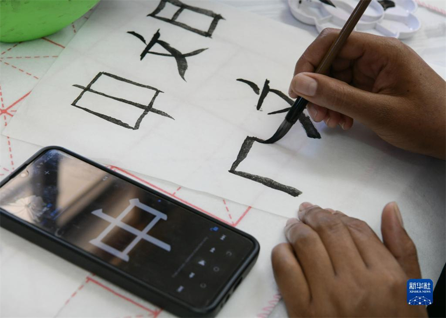 4月18日，肯尼亞學(xué)生在內(nèi)羅畢大學(xué)孔子學(xué)院舉辦的活動(dòng)上寫毛筆字?？夏醽唭?nèi)羅畢大學(xué)孔子學(xué)院18日舉辦“中文，增進(jìn)文明對話”主題活動(dòng)，慶祝即將到來的第14個(gè)聯(lián)合國中文日?？夏醽唽W(xué)生參與互動(dòng)，進(jìn)行書法、剪紙、唱中文歌等活動(dòng)。新華社記者 韓旭 攝
