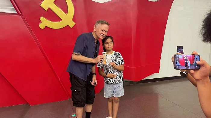 潘維廉和志愿講解員紀念合影。主辦方供圖