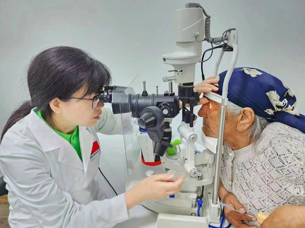 北京大學人民醫(yī)院眼科醫(yī)生鮑永珍正在為中亞白內障患者進行眼部檢查。（北京大學人民醫(yī)院供圖）