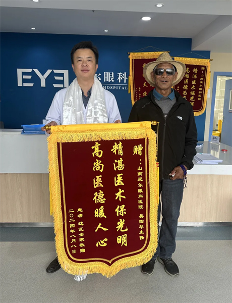 達瓦老人向吳四華（左）贈送錦旗。受訪者供圖