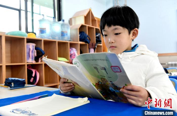 3月14日，西藏拉薩市第一小學(xué)一年級(jí)六班學(xué)生丁增樂(lè)吉在閱讀藏語(yǔ)課本?！±盍?攝