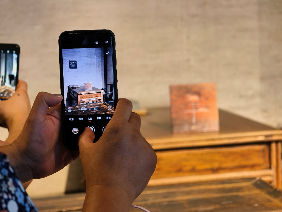 2025年7月15日，暑期研學(xué)團(tuán)小朋友在浙江省紹興市三味書屋拍攝魯迅讀書座位及課桌上的“早”字。受訪者供圖