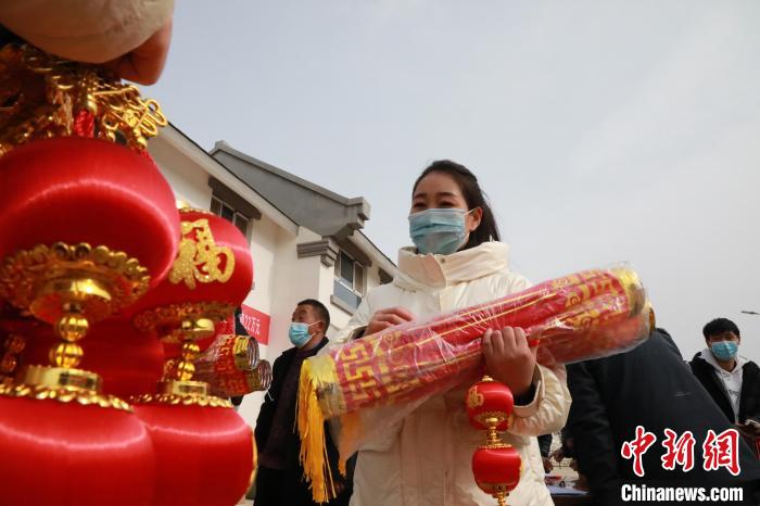 27日，蘭州新區(qū)為舟曲避險(xiǎn)搬遷移民送“春節(jié)包”，楊周馬草前往領(lǐng)取，紅色寓意來年的日子紅紅火火?！∥航ㄜ?攝