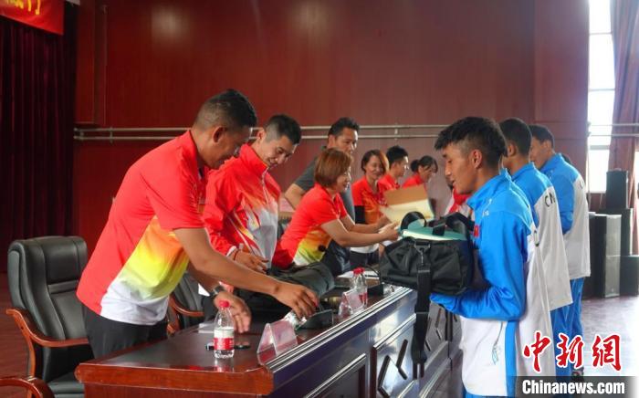 圖為世界冠軍們?yōu)槲鞑刈灾螀^(qū)體校的學生們送上暖心物資?！∪轿木?攝