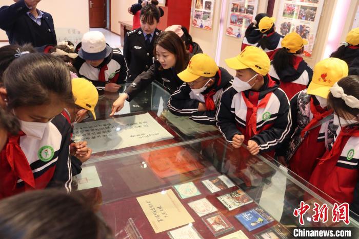 圖為亞東邊檢站民警為駐地小學生講解該站榮譽發(fā)展史。　胡利媛 攝